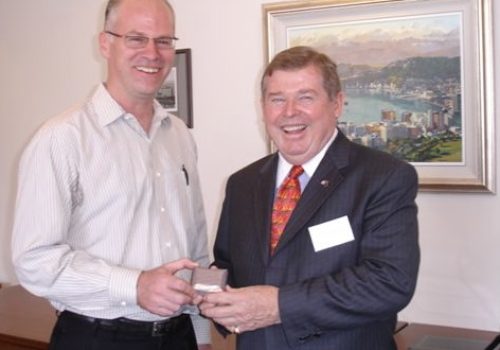 Gregory F Casagrande receiving a gift from USA Ambassador to New Zealand William McCormack.